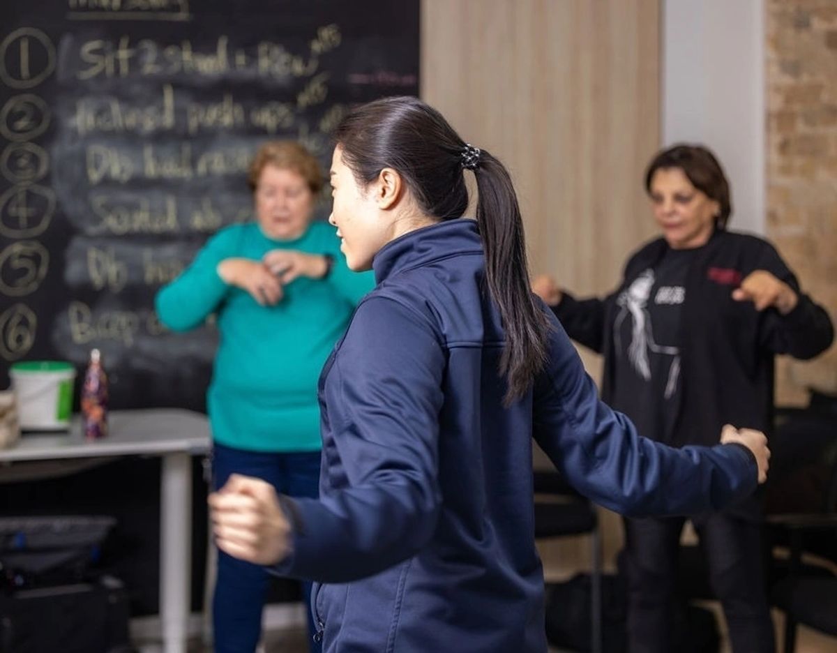 Super Rehab exercise physiologist leading a group exercise session for older adults in Sydney